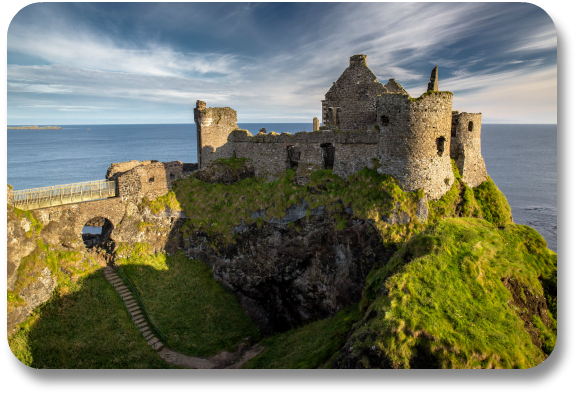 Majestic Dunluce Castle perched on a cliff overlooking the ocean.