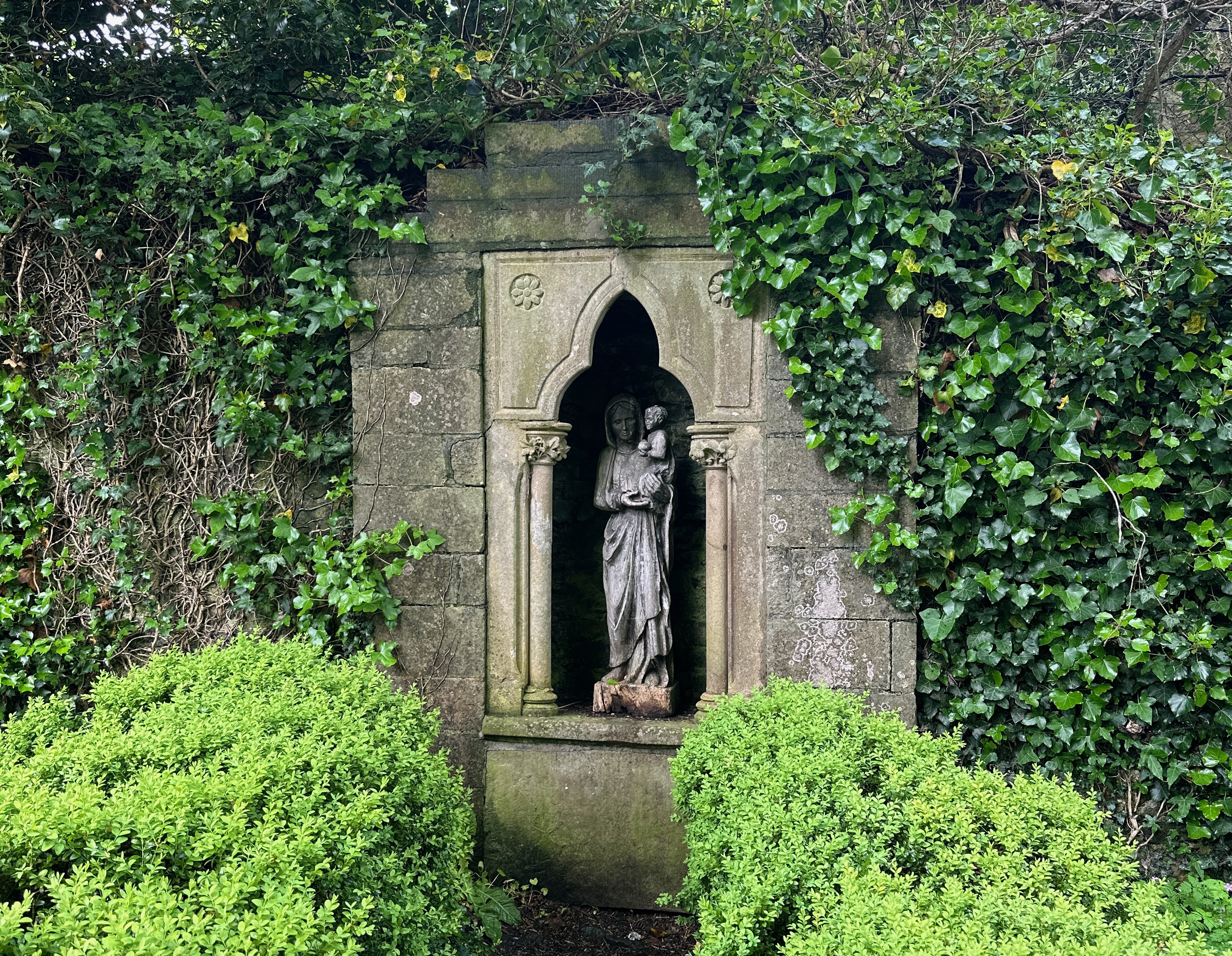 Irish Expressions: Bunratty Castle & Folk Park.  Image of statue inset in walled garden.