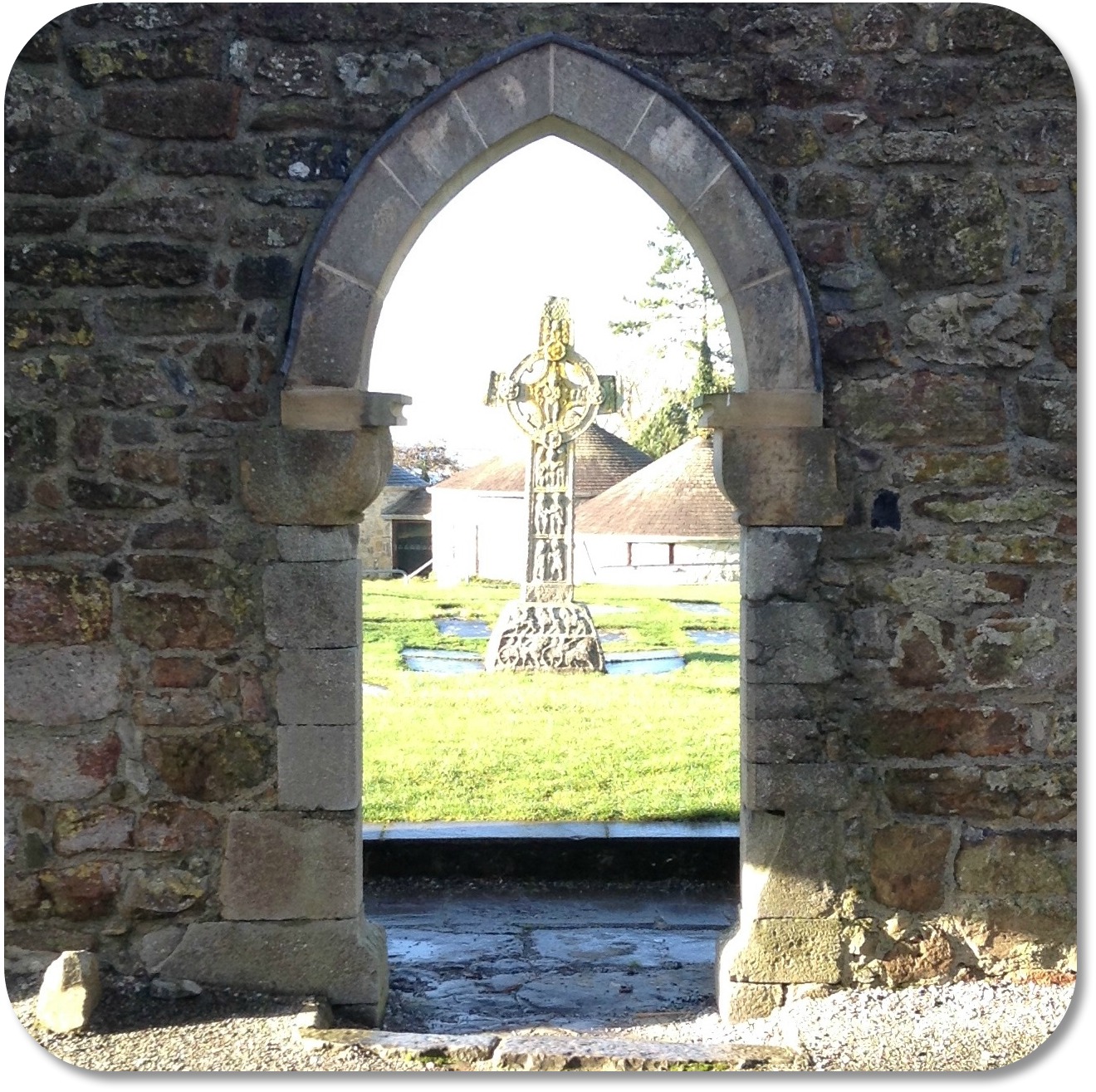 Irish Expressions:  Clonmacnoise Monastery.  Image of High Cross viewed through arched doorway.