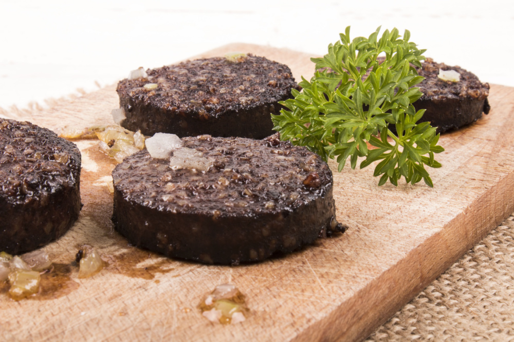 Irish Expressions:  Easy Irish Food Recipes.  Image of black pudding on wood slab, courtesy of Shutterstock.