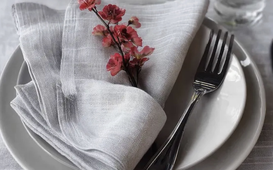 Irish linen place setting with plates, napkins and flower accent.  Courtesy of Thomas Ferguson.