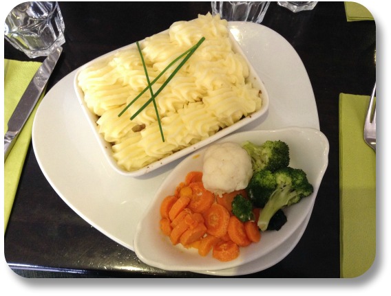 Irish Expressions:  Easy Irish Food Recipes.  Image of Shepherd's pie on triangle plate with steamed carrots.