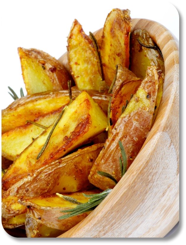 Potato wedges with rosemary in a wooden bowl.
