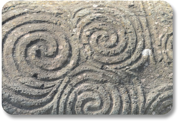 Irish Expressions: Irish Symbols.  Image of triple spirals at Newgrange courtesy of Bigstock.com.