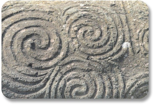 Irish Expressions: Irish Symbols.  Image of triple spirals at Newgrange courtesy of Bigstock.com.