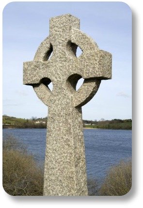 Irish Celitc Cross. Stone statue against water background.